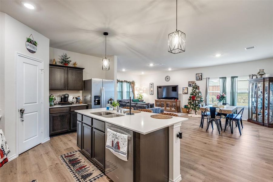Kitchen with recessed lighting, open floor plan, stainless steel appliances, hanging light fixtures, and an island with sink Kitchen with recessed lighting, open floor plan, stainless steel appliances, hanging light fixtures, and an island with sink