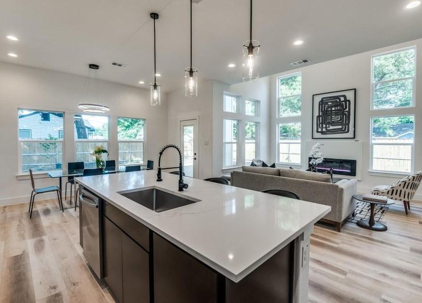 Kitchen with a healthy amount of sunlight, sink, and light wood-type flooring