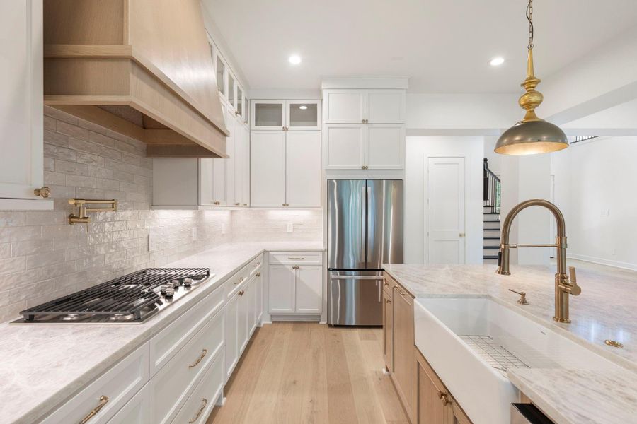 Gorgeous brushed gold fixtures and accents grace this lovely kitchen. Gorgeous brushed gold fixtures and accents grace this lovely kitchen.