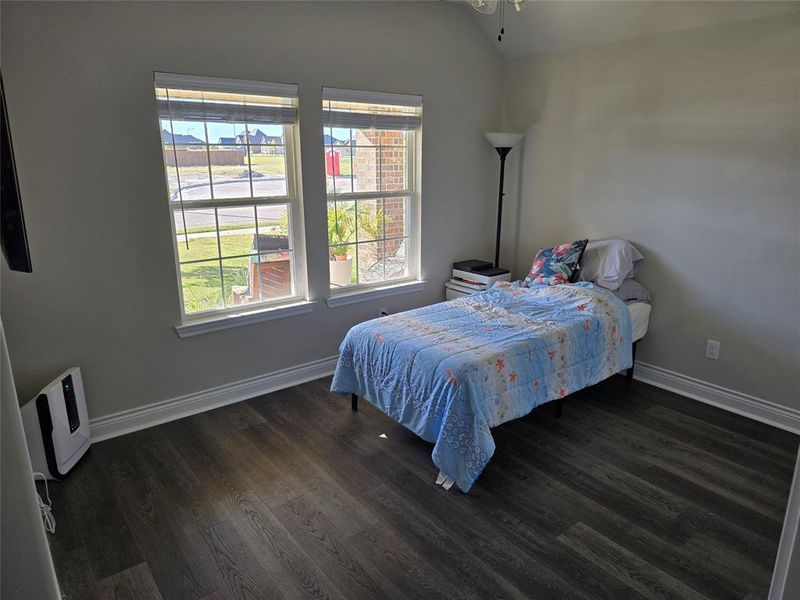 Bedroom with lofted ceiling and dark hardwood / wood-style floors