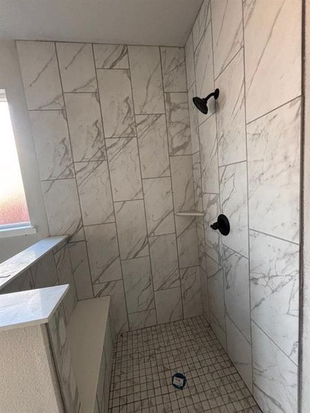 Bathroom featuring a tile shower Bathroom featuring a tile shower