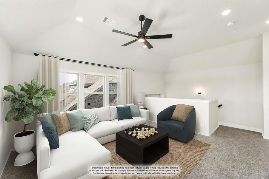 Upstairs living area with vaulted ceiling, ceiling fan, white sectional sofa, and carpet flooring