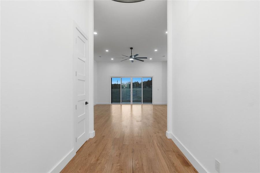 Hallway featuring recessed lighting and light wood-style flooring