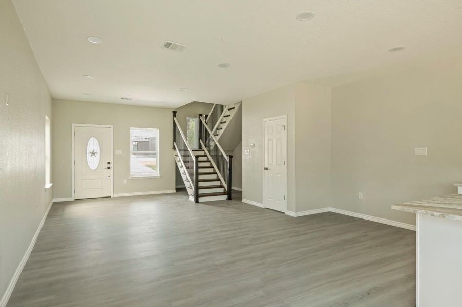Foyer entrance featuring stairs, light wood-type flooring, and recessed lighting