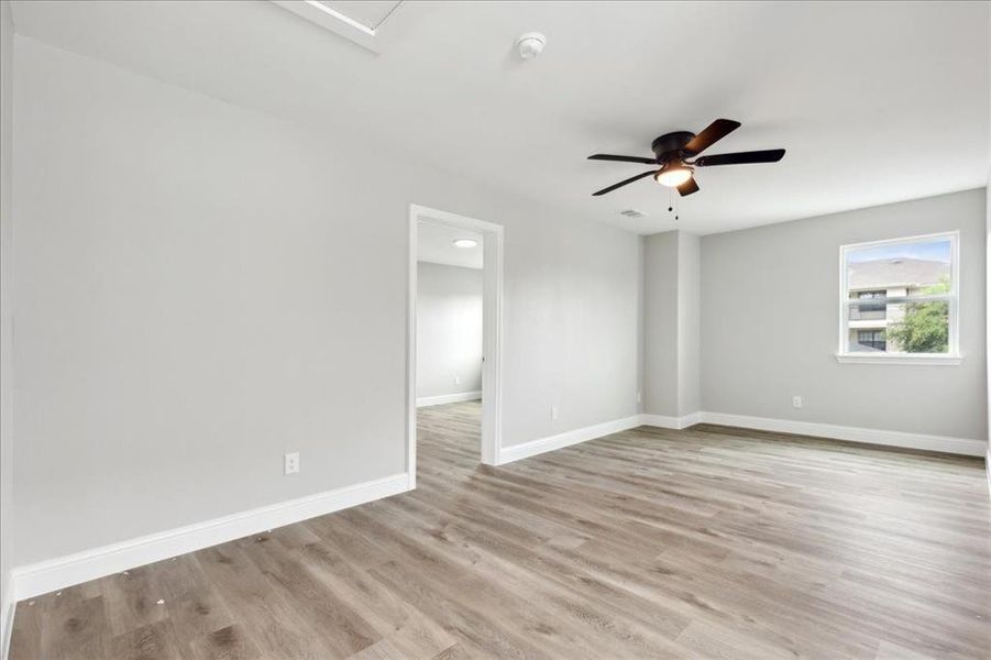 Spare room featuring ceiling fan and light hardwood / wood-style floors