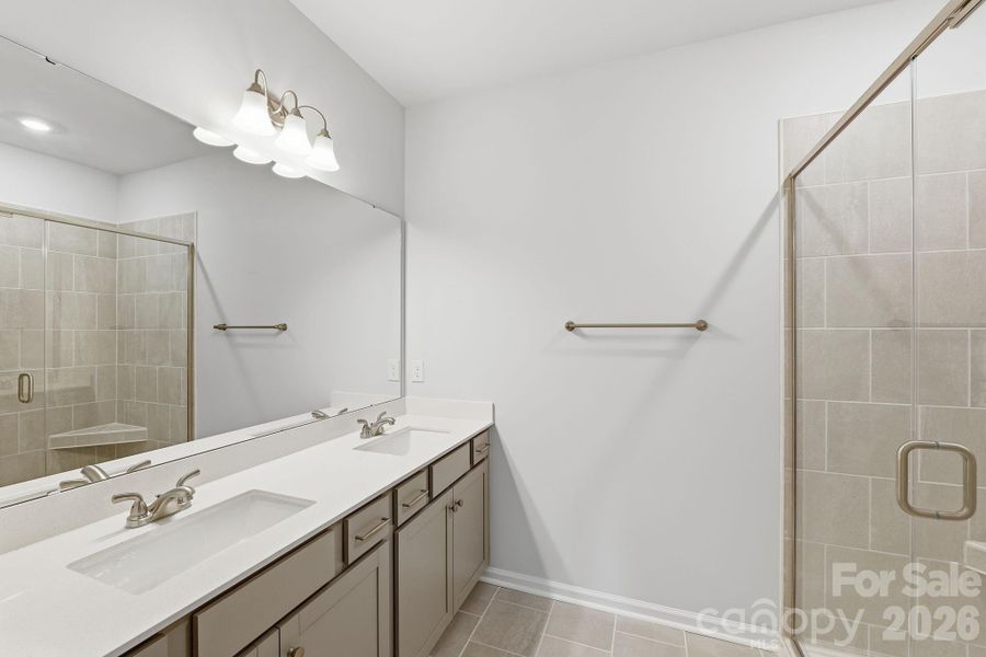 Primary Bathroom with Tiled walk-in shower, linen closet and private water closet