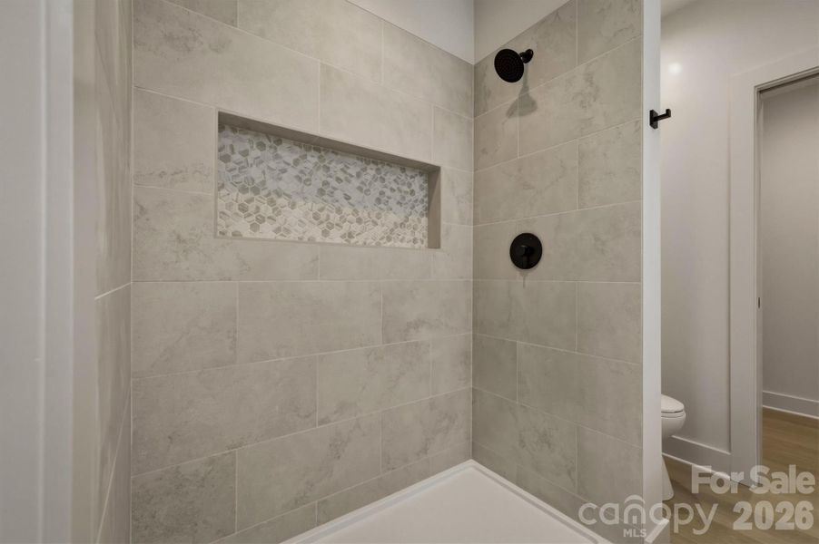 Here is a closer look at the walk-in shower of the fourth bathroom that has a custom shower niche. Here is a closer look at the walk-in shower of the fourth bathroom that has a custom shower niche.