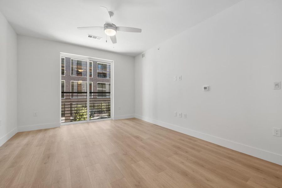 Unfurnished room with a ceiling fan and light wood-type flooring