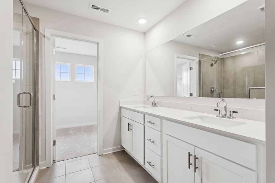 A bathroom with a sink and a mirror. A bathroom with a sink and a mirror.