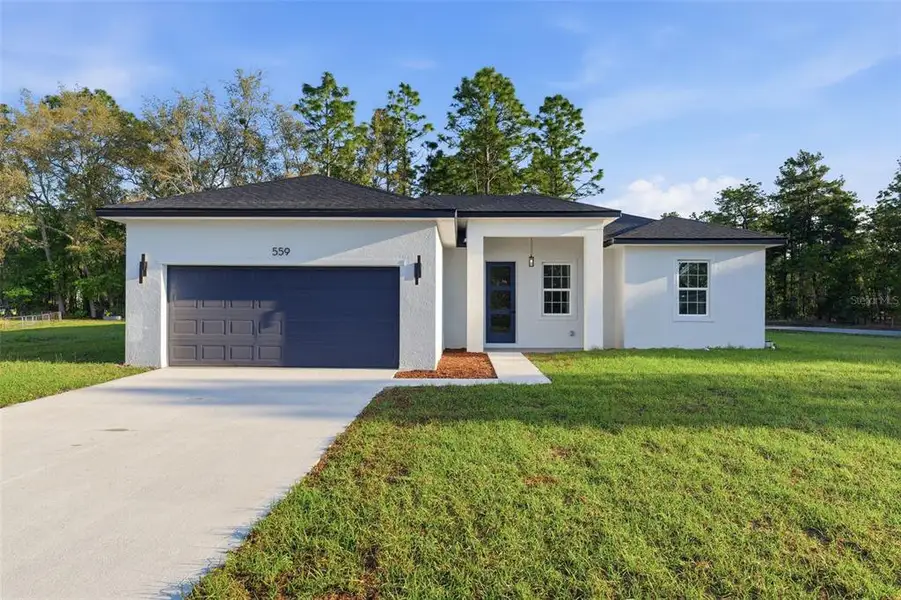 Front exterior of a new home in , Dunnellon, FL, highlighting curb appeal (Image 2). Front exterior of a new home in , Dunnellon, FL, highlighting curb appeal (Image 2).