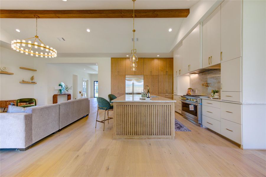 Designed for effortless entertaining, the expansive open-concept floor plan seamlessly connects the chef’s kitchen, dining area, and great room, creating a sophisticated setting for gatherings both intimate and grand. Soaring ceilings, designer lighting, and walls of glass enhance the sense of space while allowing conversation and connection to flow naturally throughout the heart of the home.