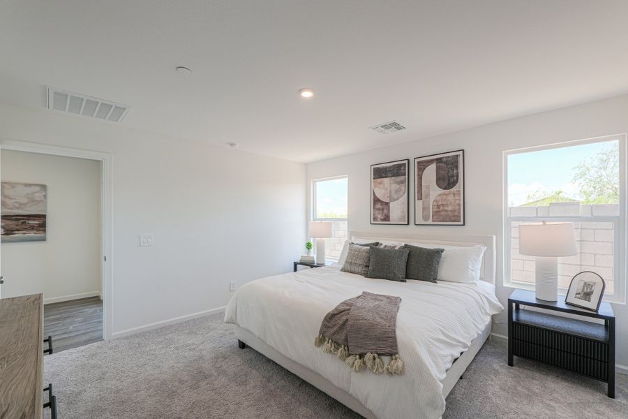 A bedroom with a bed and a table. A bedroom with a bed and a table.