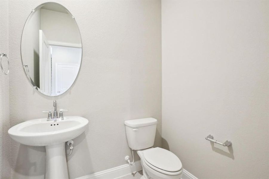 Bathroom with toilet and baseboards Bathroom with toilet and baseboards