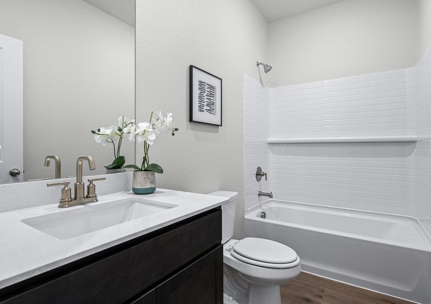 The secondary bathroom has a sprawling vanity space and a shower-tub combo. The secondary bathroom has a sprawling vanity space and a shower-tub combo.