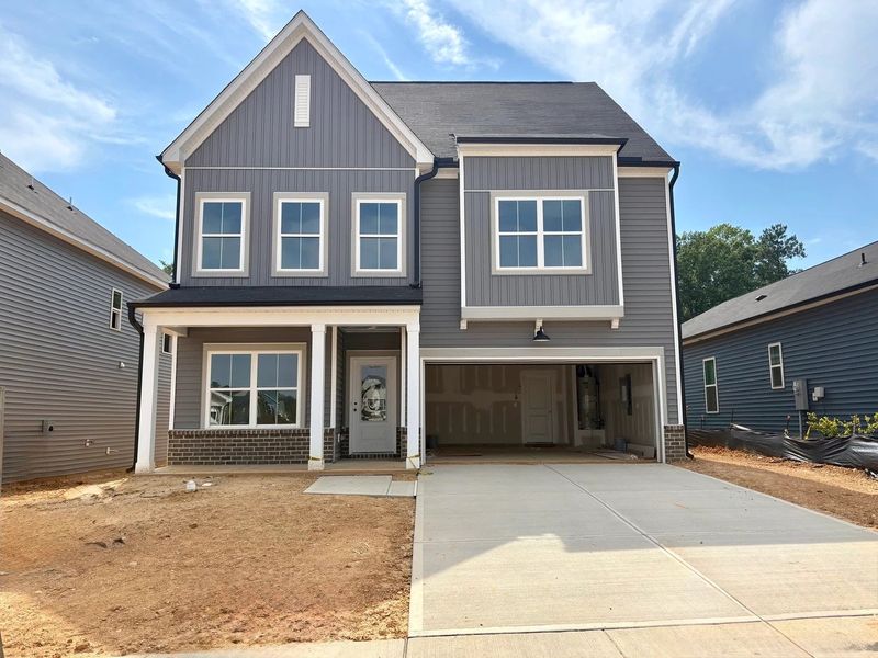 Front exterior of a new home in Crescent Mills, Wilson's Mills, NC, highlighting curb appeal (Image 1). Front exterior of a new home in Crescent Mills, Wilson's Mills, NC, highlighting curb appeal (Image 1).