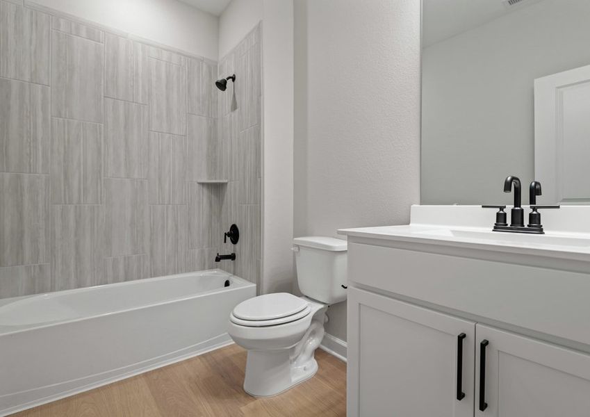 Secondary bathroom with tile detail in the tub