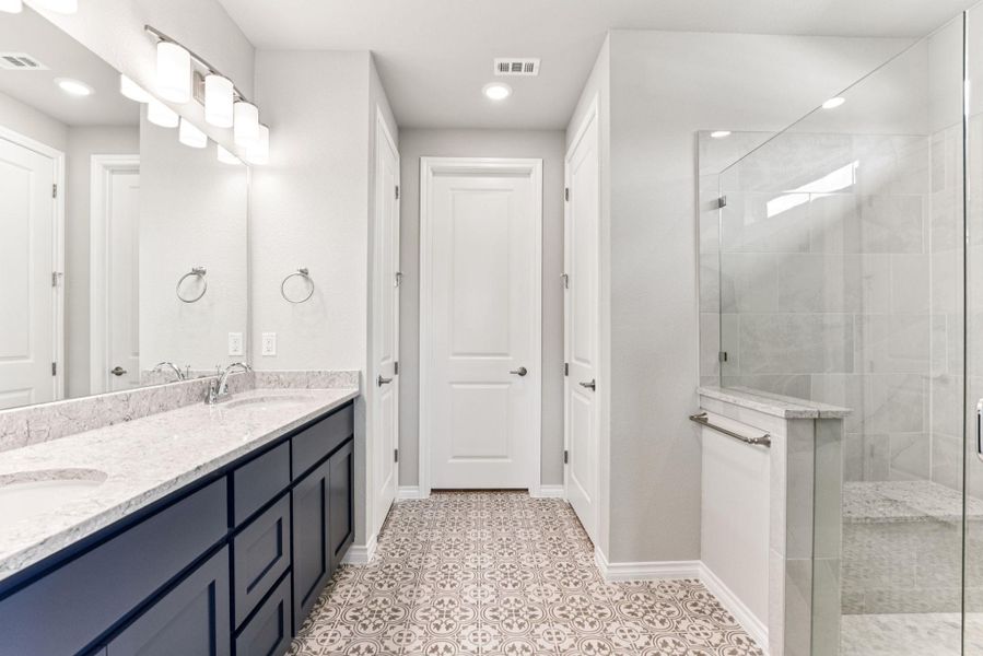 Bathroom featuring double vanity, a walk in shower, and recessed lighting Bathroom featuring double vanity, a walk in shower, and recessed lighting