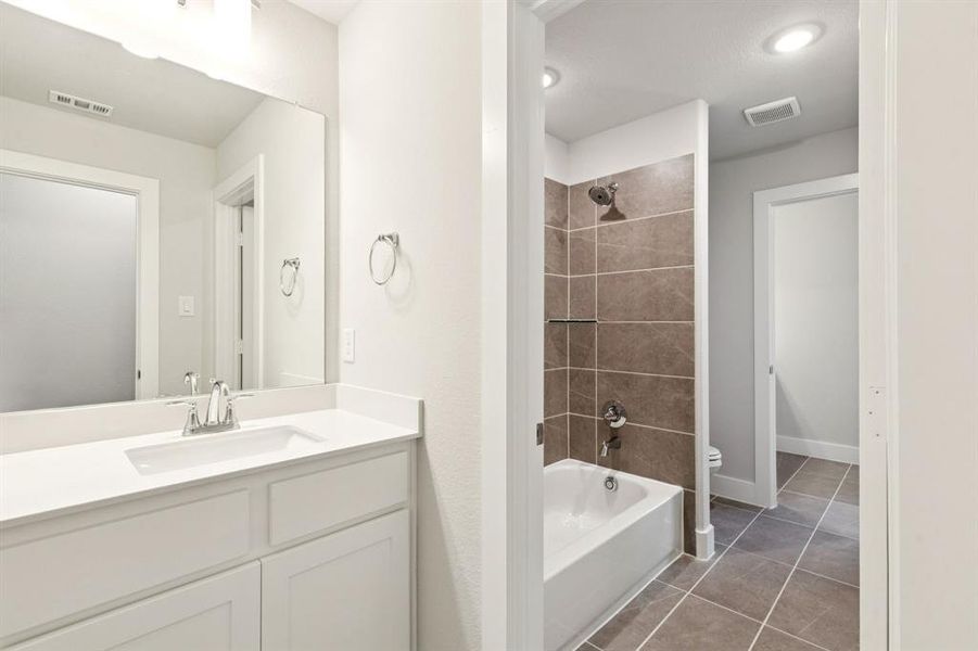 Bathroom featuring shower / washtub combination, light tile patterned flooring, and vanity Bathroom featuring shower / washtub combination, light tile patterned flooring, and vanity