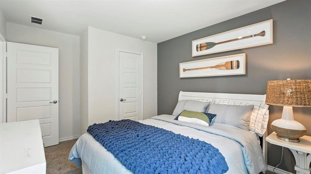 Carpeted bedroom with baseboards