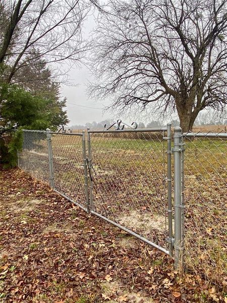 Fenced backyard gate into larger fenced area Fenced backyard gate into larger fenced area