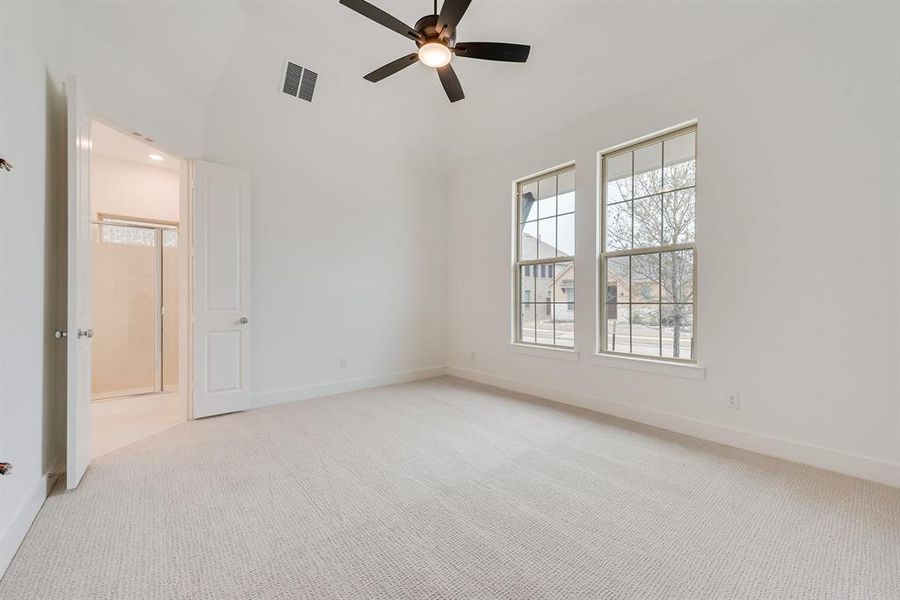 Unfurnished bedroom with light carpet, a ceiling fan, connected bathroom, and recessed lighting Unfurnished bedroom with light carpet, a ceiling fan, connected bathroom, and recessed lighting