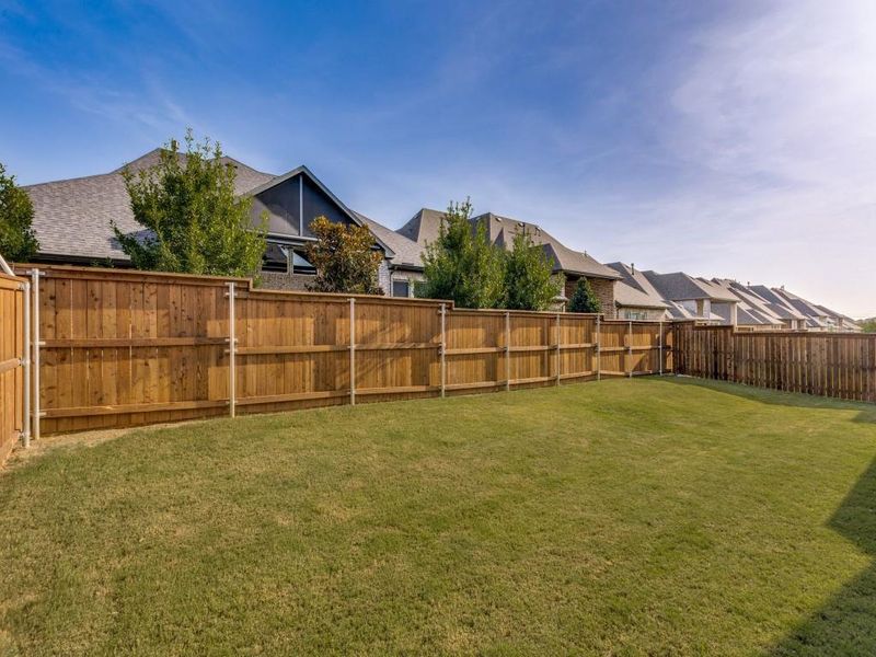Fenced backyard featuring a residential view