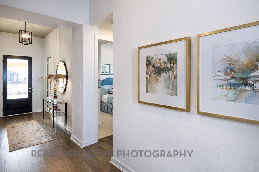 Entrance foyer featuring wood finished floors and a chandelier