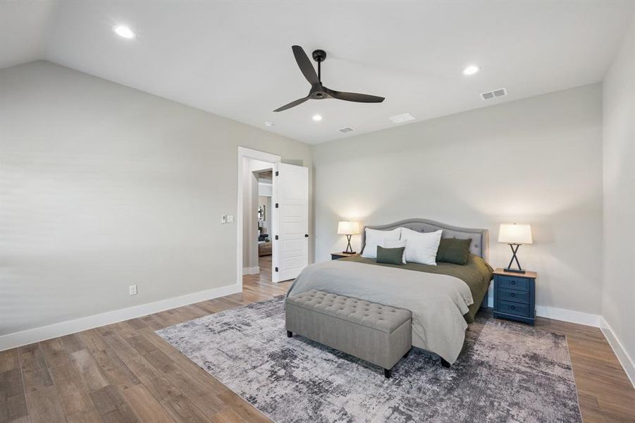 Bedroom with wood finished floors, a ceiling fan, and recessed lighting