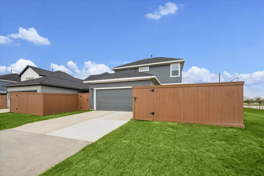 Front exterior of a new home in Elyson, Katy, TX, highlighting curb appeal (Image 2).