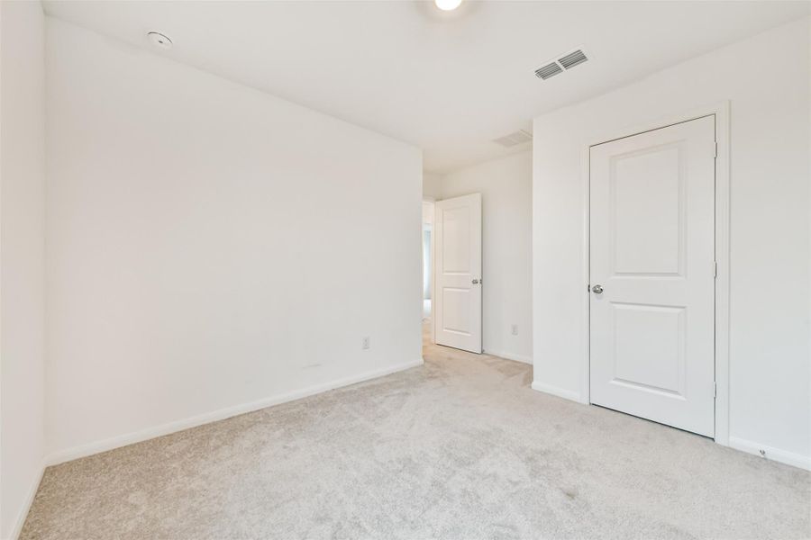 Another view of bedroom #2 is simple and ready for customization.