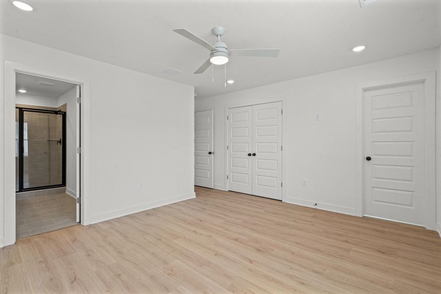 Wood-finish flooring, recessed lighting, and a ceiling fan with integrated lighting