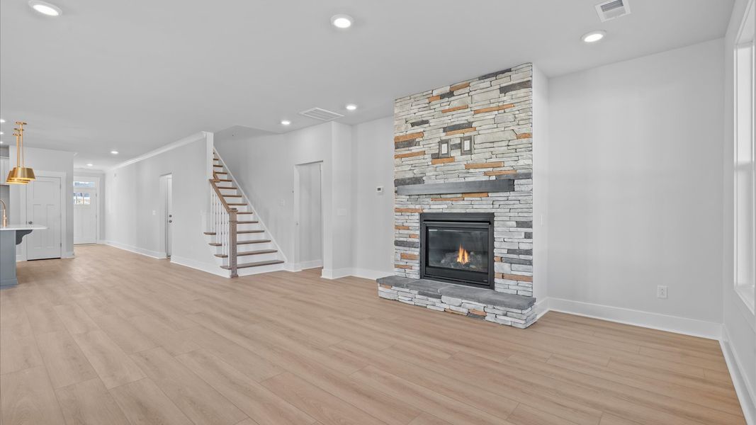 Vibrant and welcoming family room anchored by clean lines, tasteful materials, and abundant light