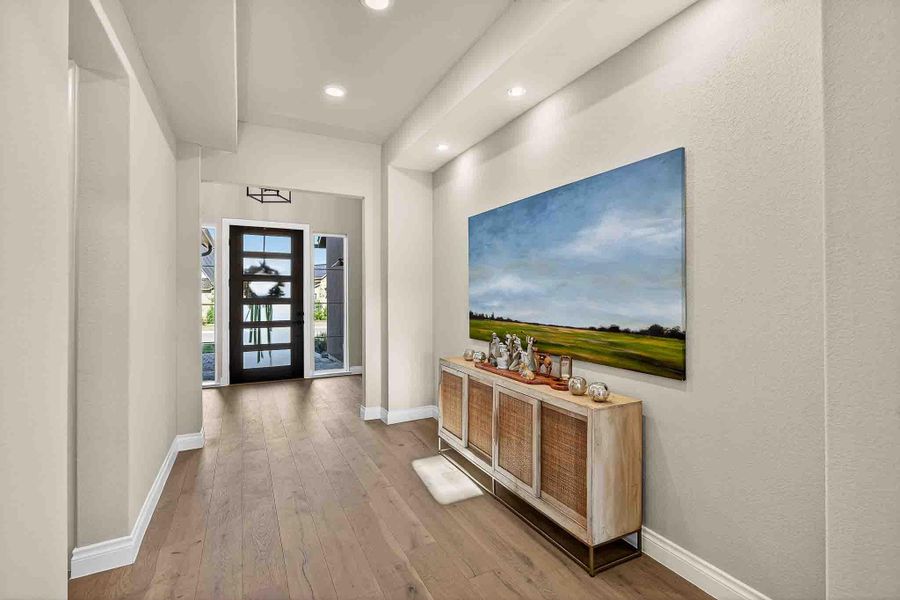 Entryway featuring hardwood / wood-style floors and recessed lighting