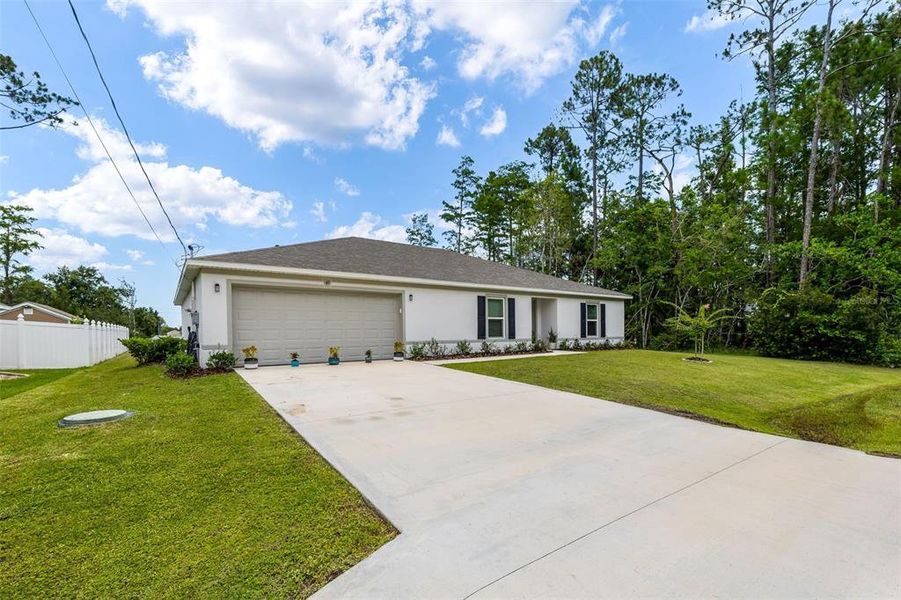Front exterior of a new home in Palm Coast, Palm Coast, FL, highlighting curb appeal (Image 21). Front exterior of a new home in Palm Coast, Palm Coast, FL, highlighting curb appeal (Image 21).