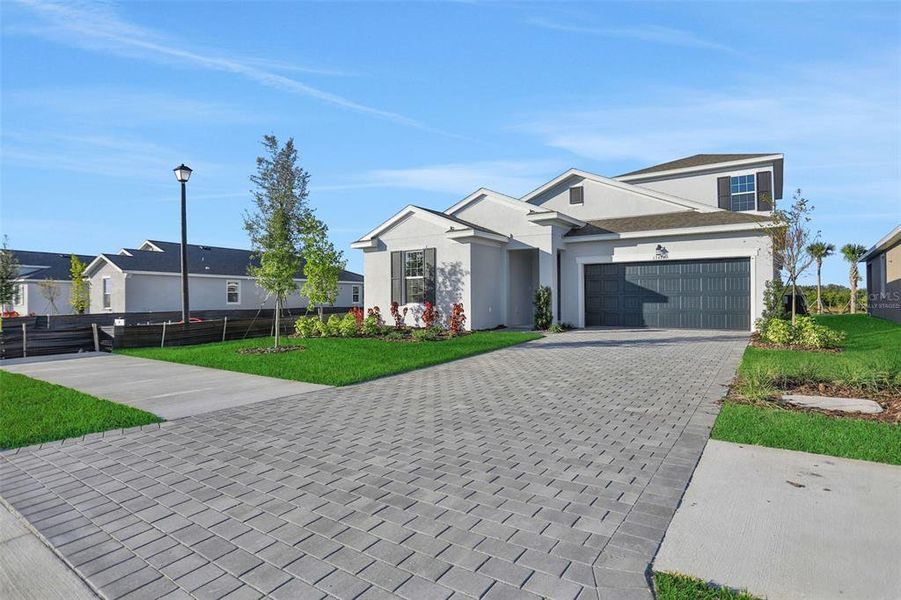 Front exterior of a new home in Turnleaf, Punta Gorda, FL, highlighting curb appeal (Image 25).