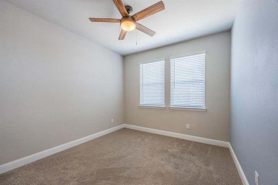 11' x 10' Secondary bedroom, with ceiling fan and window blinds - View