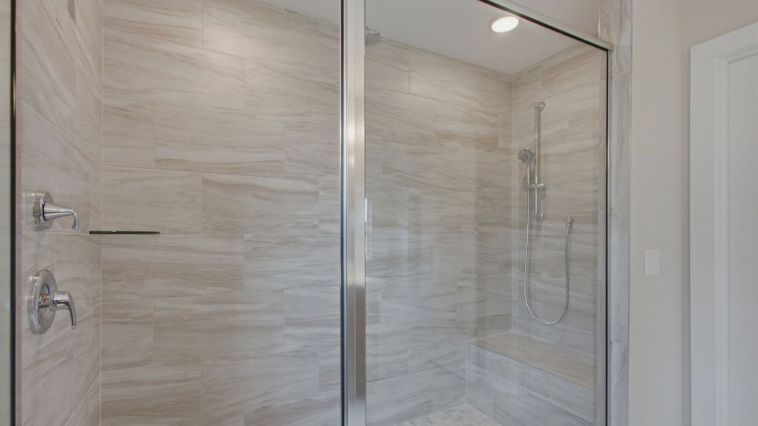 Large tiled walk-in shower for primary bathroom