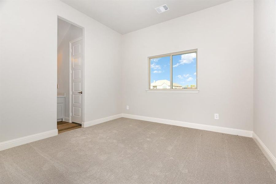Empty room with baseboards and light carpet
