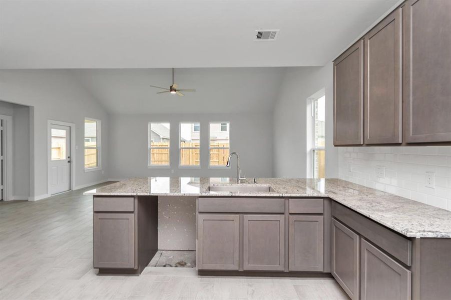 All of this overlooks your expansive family room, creating a perfect space for culinary delights and family gatherings. Sample photo of completed home with similar floor plan. As-built interior colors and selections may vary.