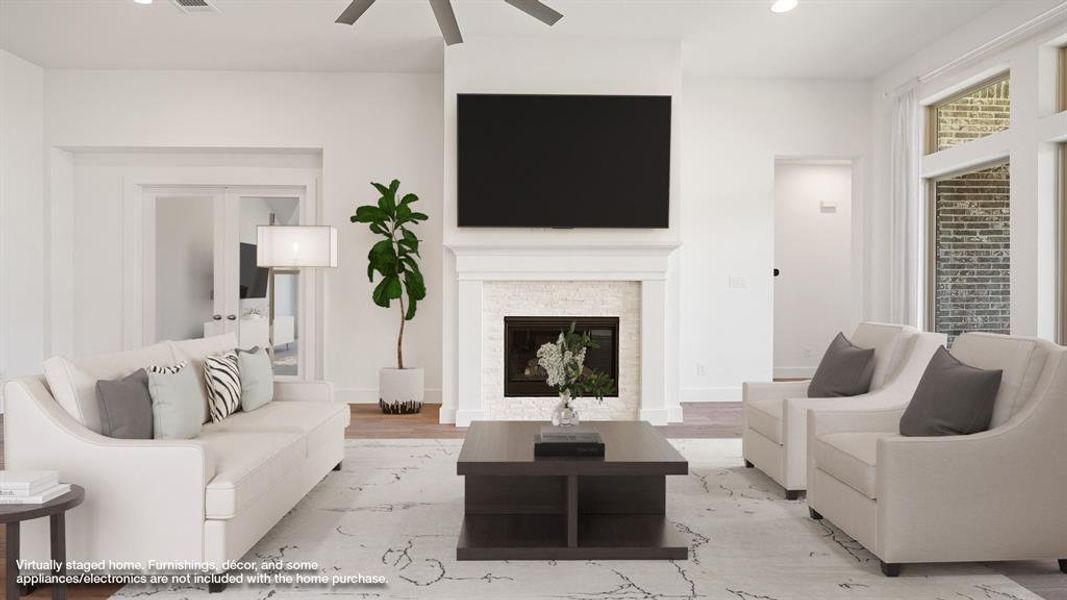 Living room featuring light hardwood / wood-style floors and ceiling fan