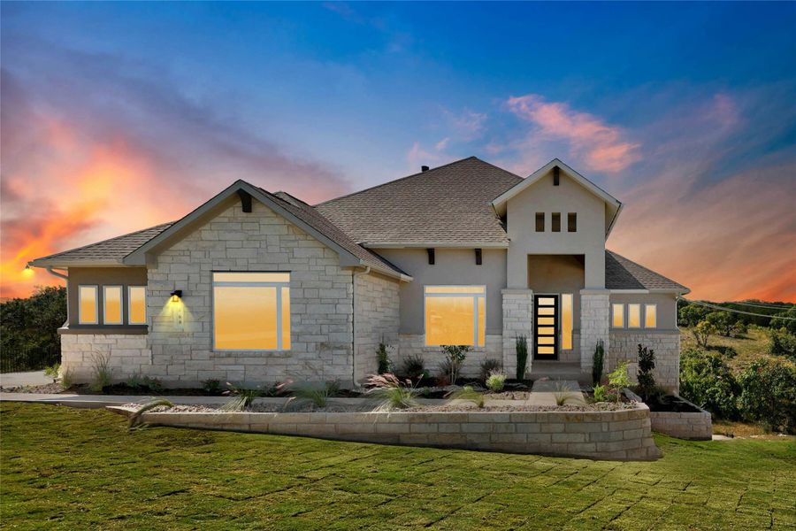View of front facade featuring a yard, stone siding, roof with shingles, and stucco siding View of front facade featuring a yard, stone siding, roof with shingles, and stucco siding