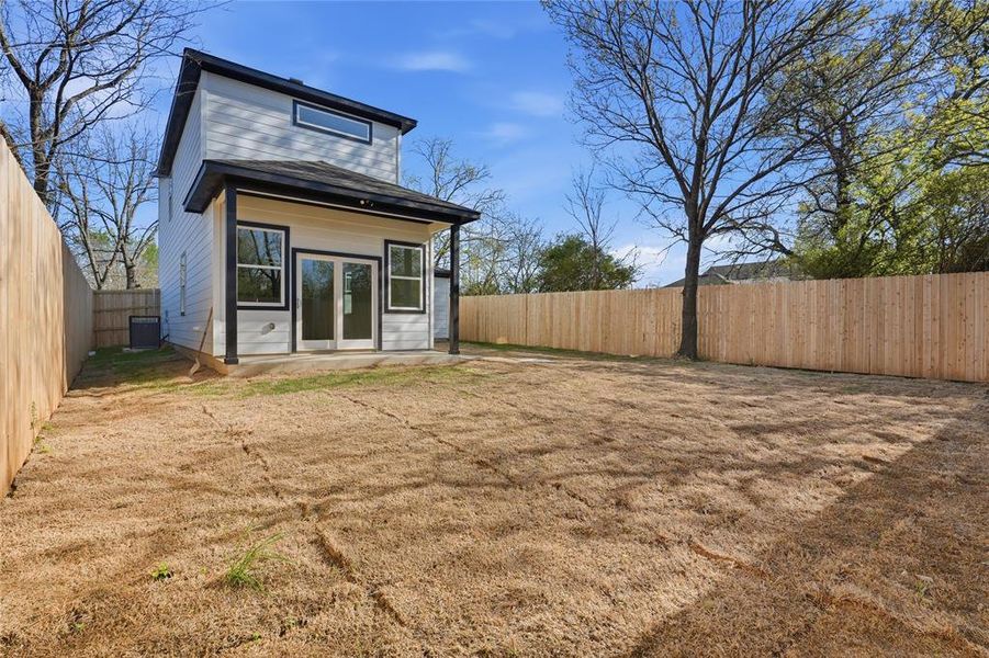 Back of property featuring french doors, a patio area, and a fenced backyard Back of property featuring french doors, a patio area, and a fenced backyard