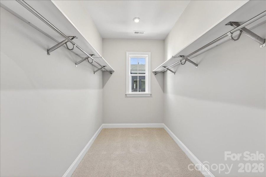 Primary walk-in closet with window Primary walk-in closet with window