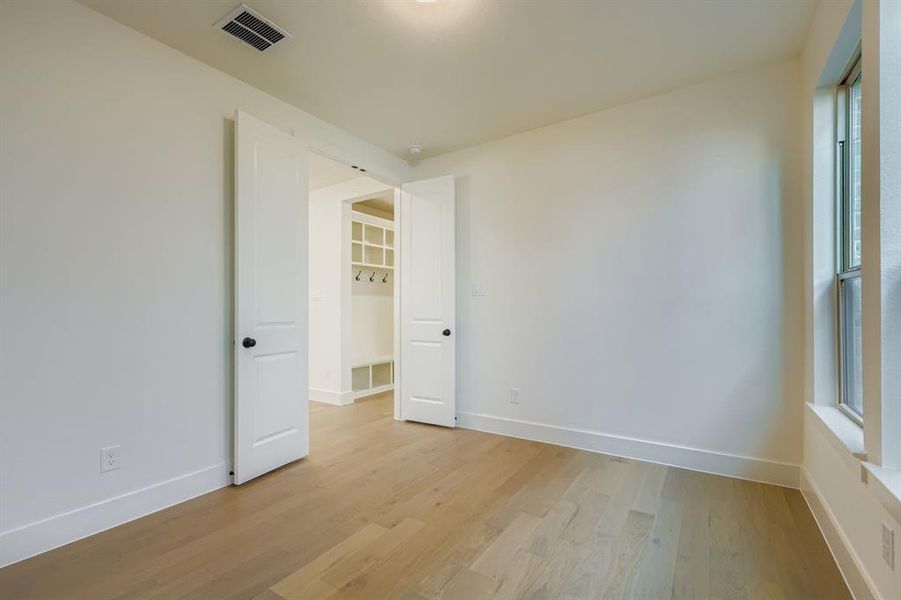 Spare room with light wood-type flooring and baseboards