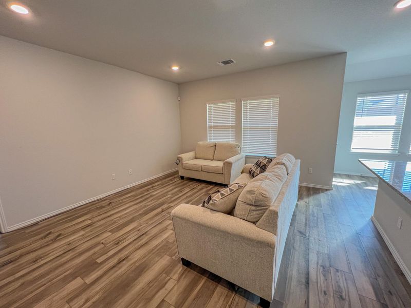 Living room with recessed lighting and wood finished floors