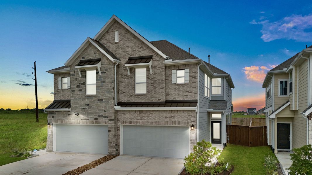 Front exterior of a new home in Meridiana, Manvel, TX, highlighting curb appeal (Image 14).