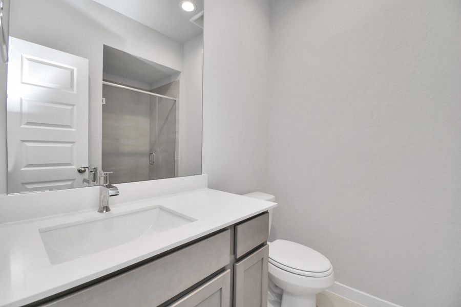 Secondary bath features tile flooring, bath/shower combo with tile surround, light stained wood cabinets, beautiful light countertop. Sample photo of completed home with similar floor plan. Actual colors and selections may vary. Secondary bath features tile flooring, bath/shower combo with tile surround, light stained wood cabinets, beautiful light countertop. Sample photo of completed home with similar floor plan. Actual colors and selections may vary.