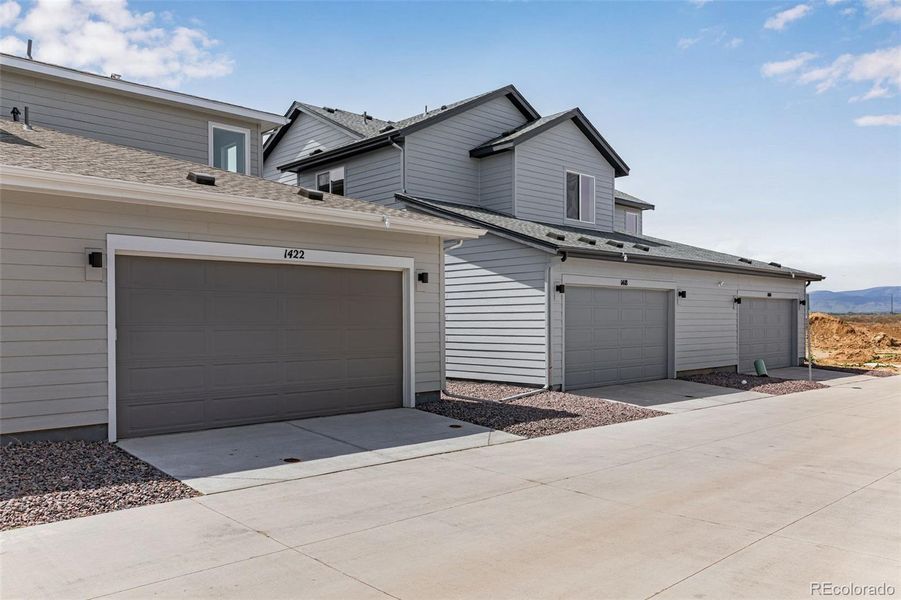 Front exterior of a new home in Sugar Mill Village, Longmont, CO, highlighting curb appeal (Image 15).