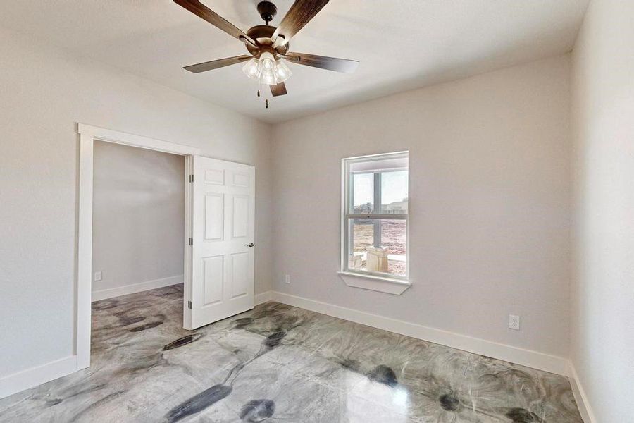 Empty room with baseboards and a ceiling fan