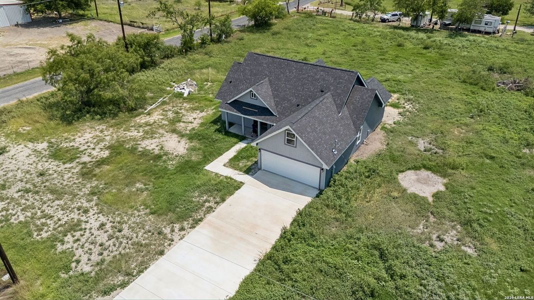 Front exterior of a new home in , Natalia, TX, highlighting curb appeal (Image 24).
